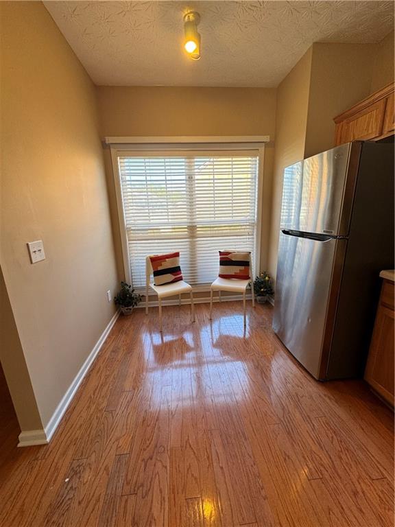 801 Old Peachtree Road Northwest, Unit 8 Lawrenceville, GA 30043 - Photo 20 of 26 a living room with stainless steel appliances furniture refrigerator and a wooden floor