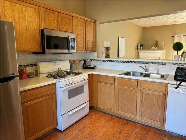 a kitchen with cabinets a sink and appliances