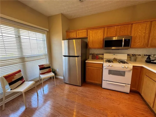 a kitchen with a stove a sink and a microwave