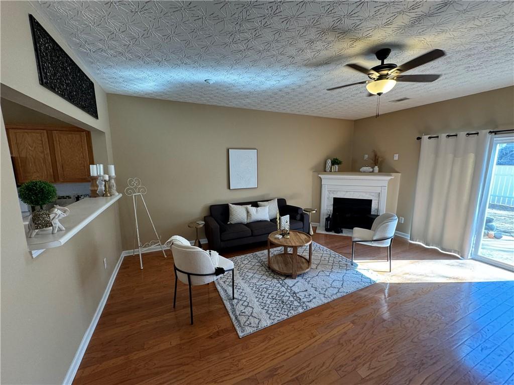 801 Old Peachtree Road Northwest, Unit 8 Lawrenceville, GA 30043 - Photo 4 of 26 a living room with furniture a fireplace and a flat screen tv