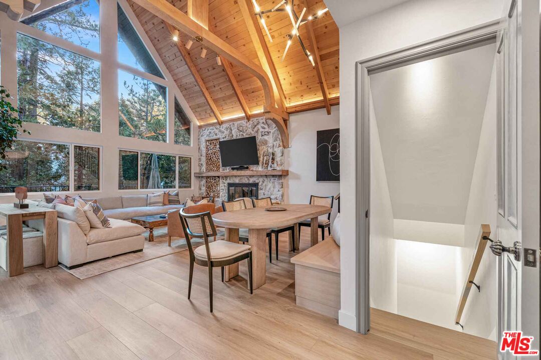 27643 West Shore Road, Unit 2 Lake Arrowhead, CA 92352 - Photo 16 of 31 a living room with furniture a fireplace and a flat screen tv