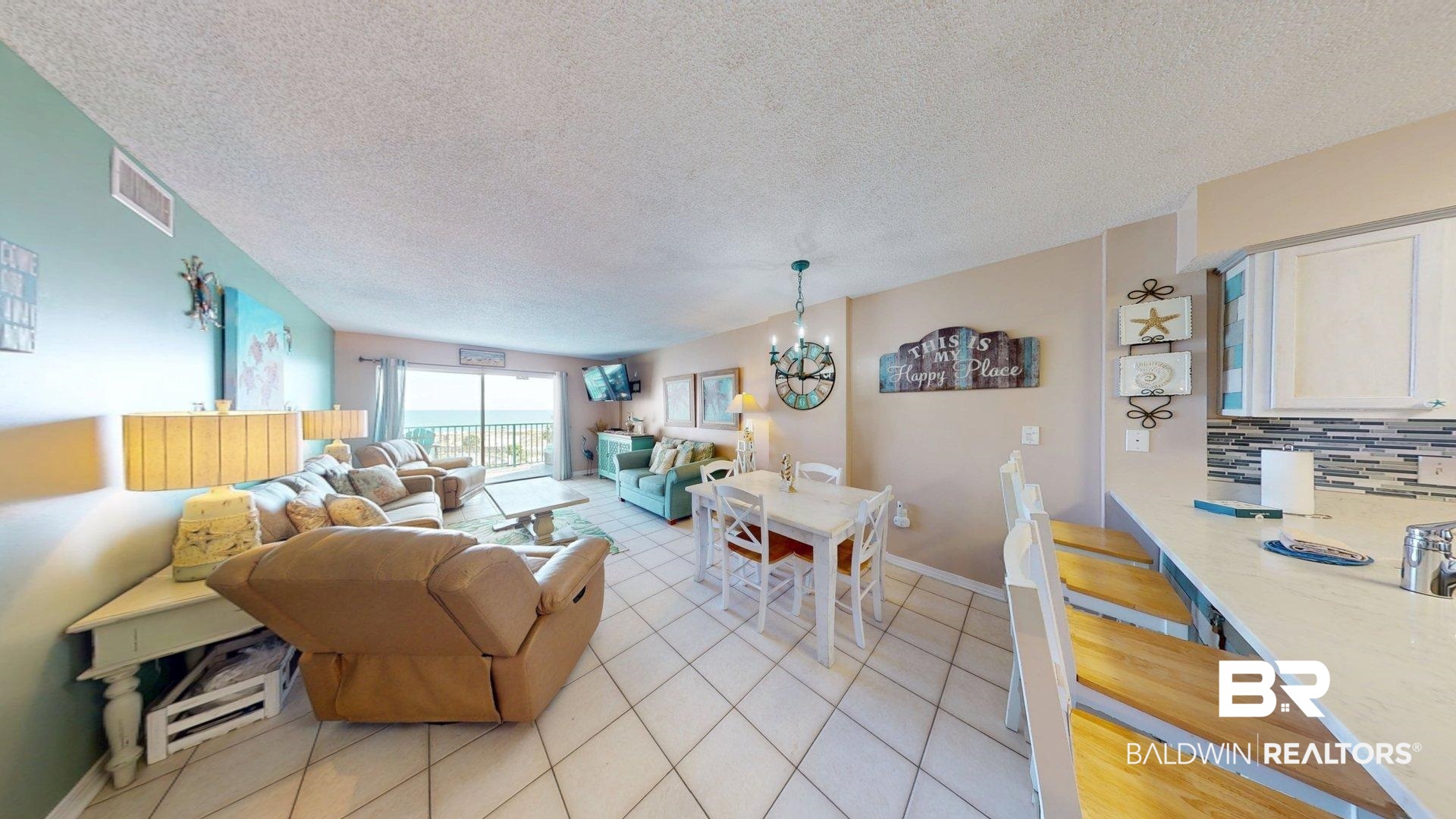 645 Plantation Road, Unit 6503 Gulf Shores, AL 36542 - Photo 14 of 53 Living room with a textured ceiling, light tile patterned floors, and a chandelier