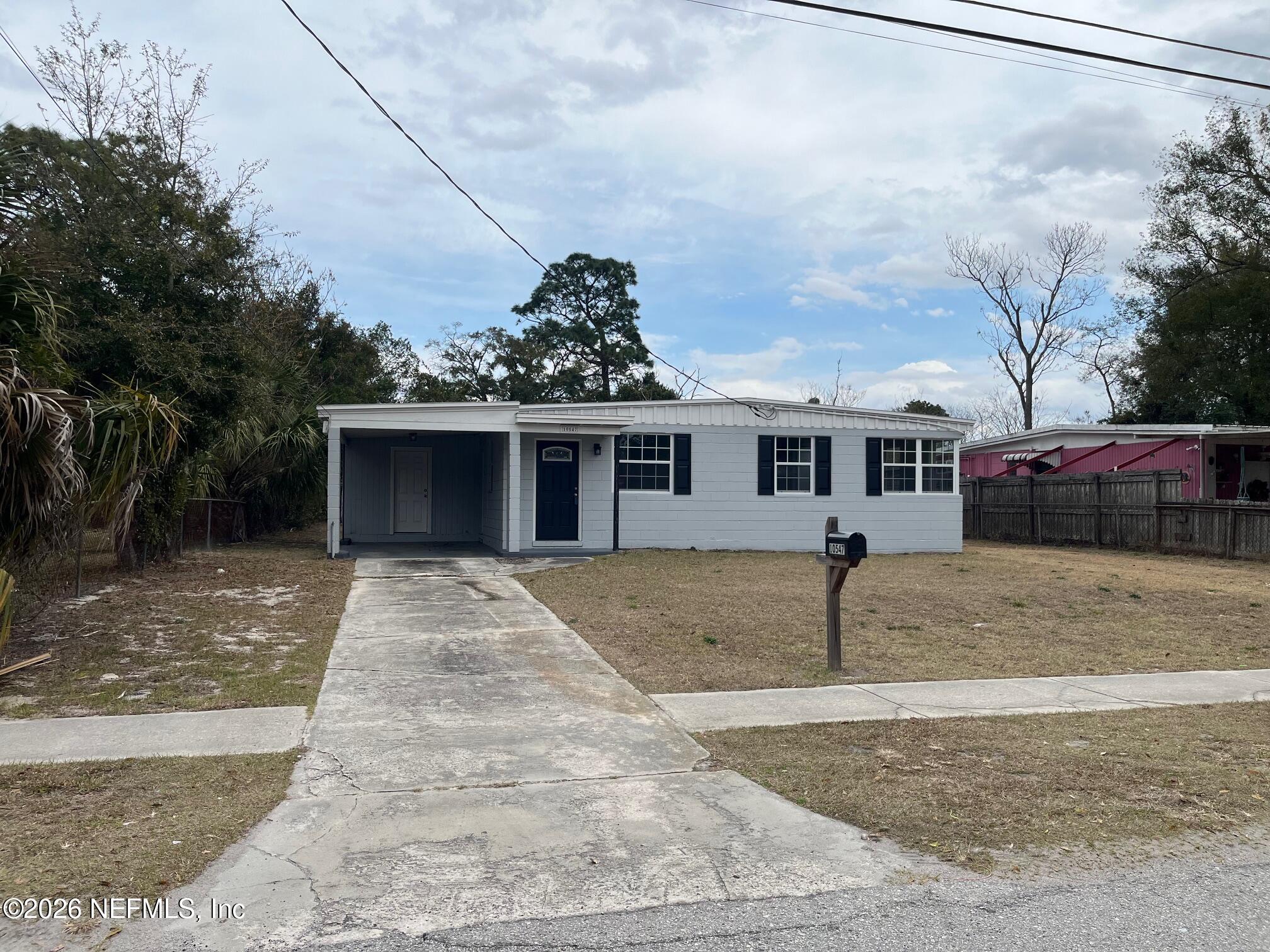 10547 Briarcliff Road East Jacksonville, FL 32218 - Photo 2 of 33 a front view of a house with a yard and garage