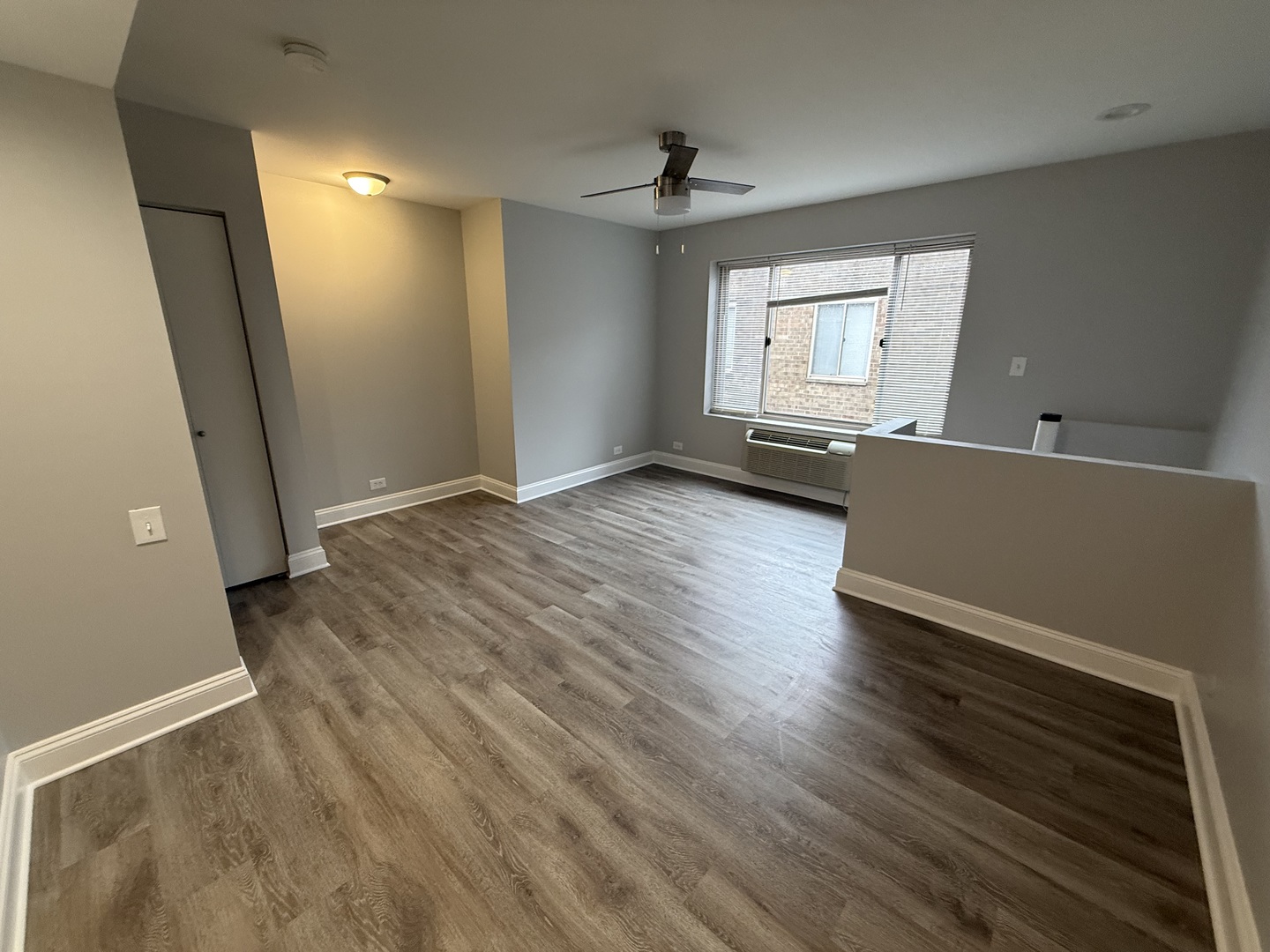 744 West Gordon Terrace, Unit 308 Chicago, IL 60613 - Photo 11 of 15 an empty room with wooden floor and windows