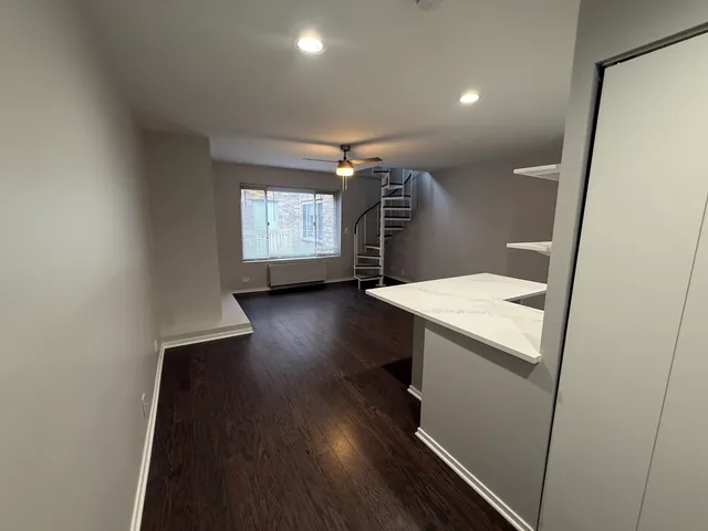 a room with wooden floor and windows
