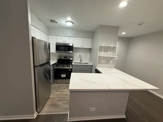a kitchen with a refrigerator and a sink