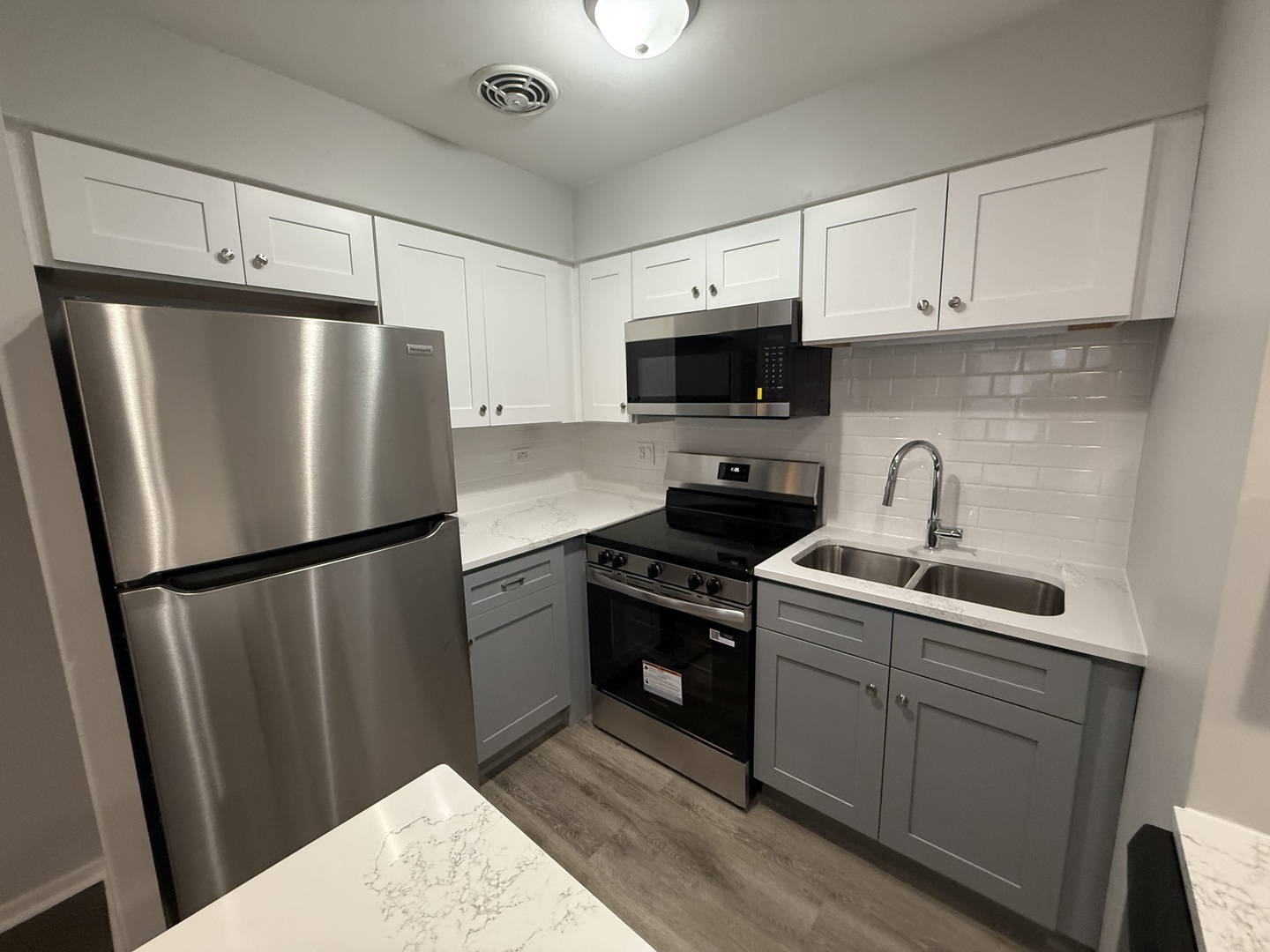 744 West Gordon Terrace, Unit 308 Chicago, IL 60613 - Photo 6 of 15 a kitchen with stainless steel appliances a refrigerator sink and microwave