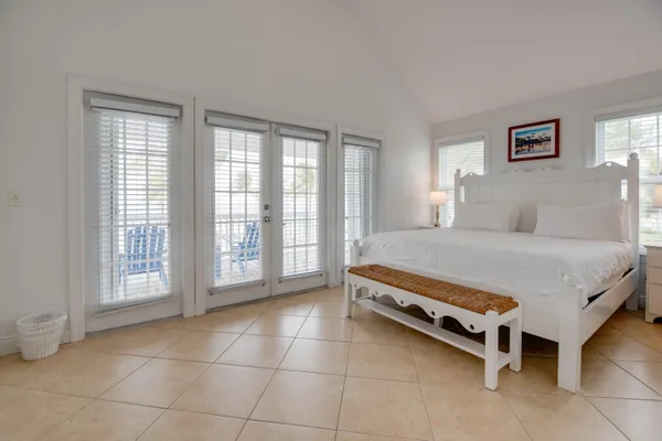 a large bed sitting in a bedroom next to a window