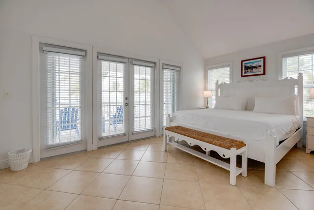 a large bed sitting in a bedroom next to a window