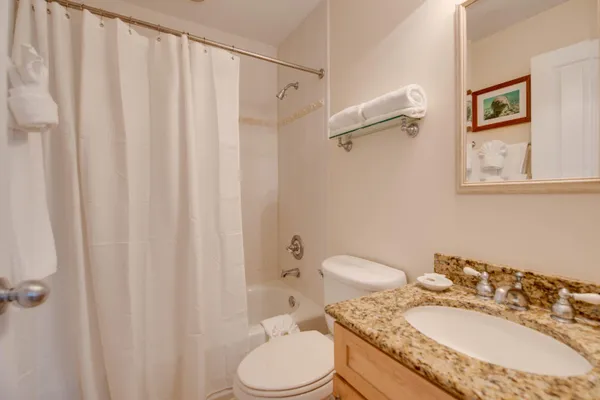 a view of a white house with a big yard and palm trees