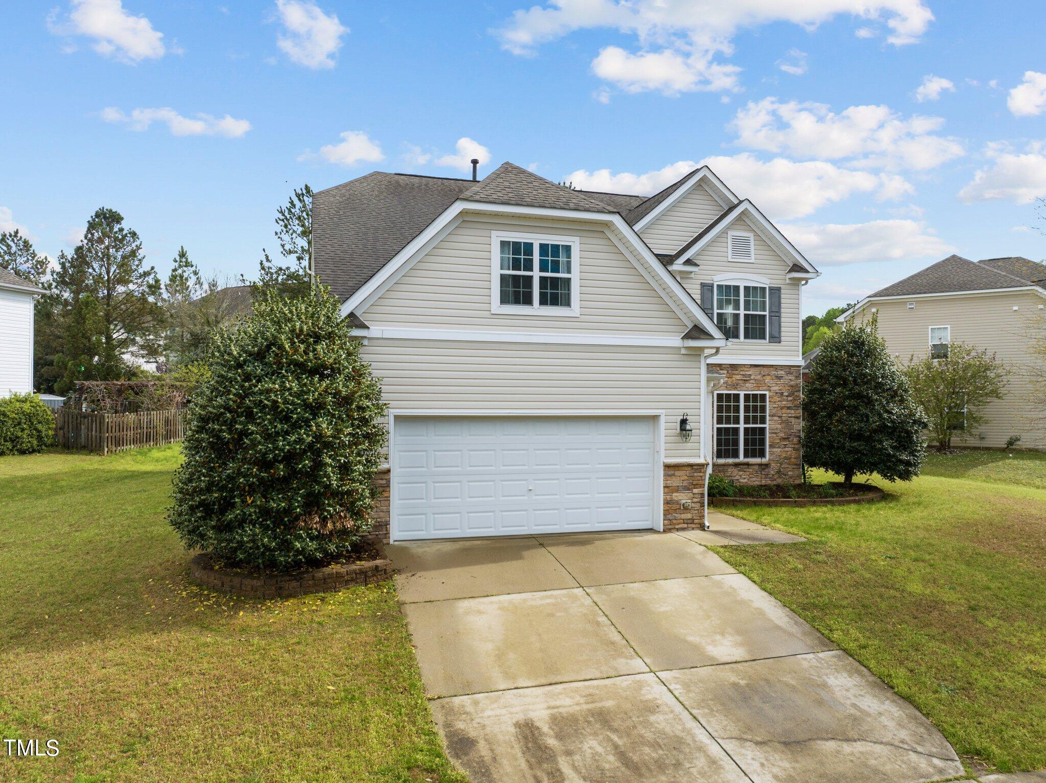 5245 Holly Ridge Farm Road Raleigh, NC 27616 - Photo 3 of 49 a front view of a house with garden