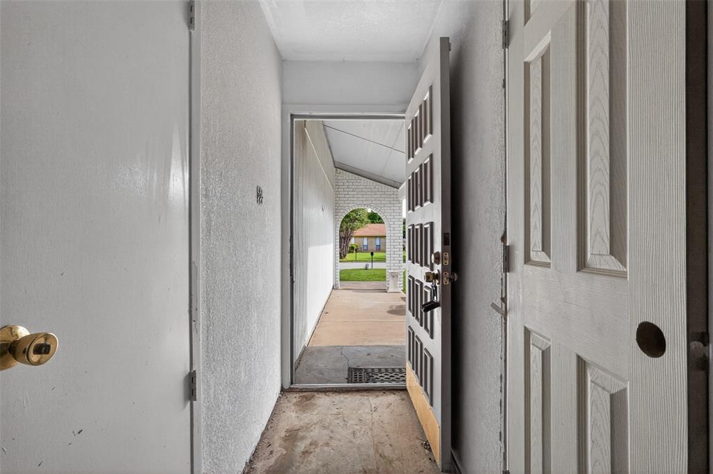 1212 Manning Road Benbrook, TX 76126 - Photo 5 of 20 Entryway featuring a paneled door, a brass-toned doorknob, and a covered porch