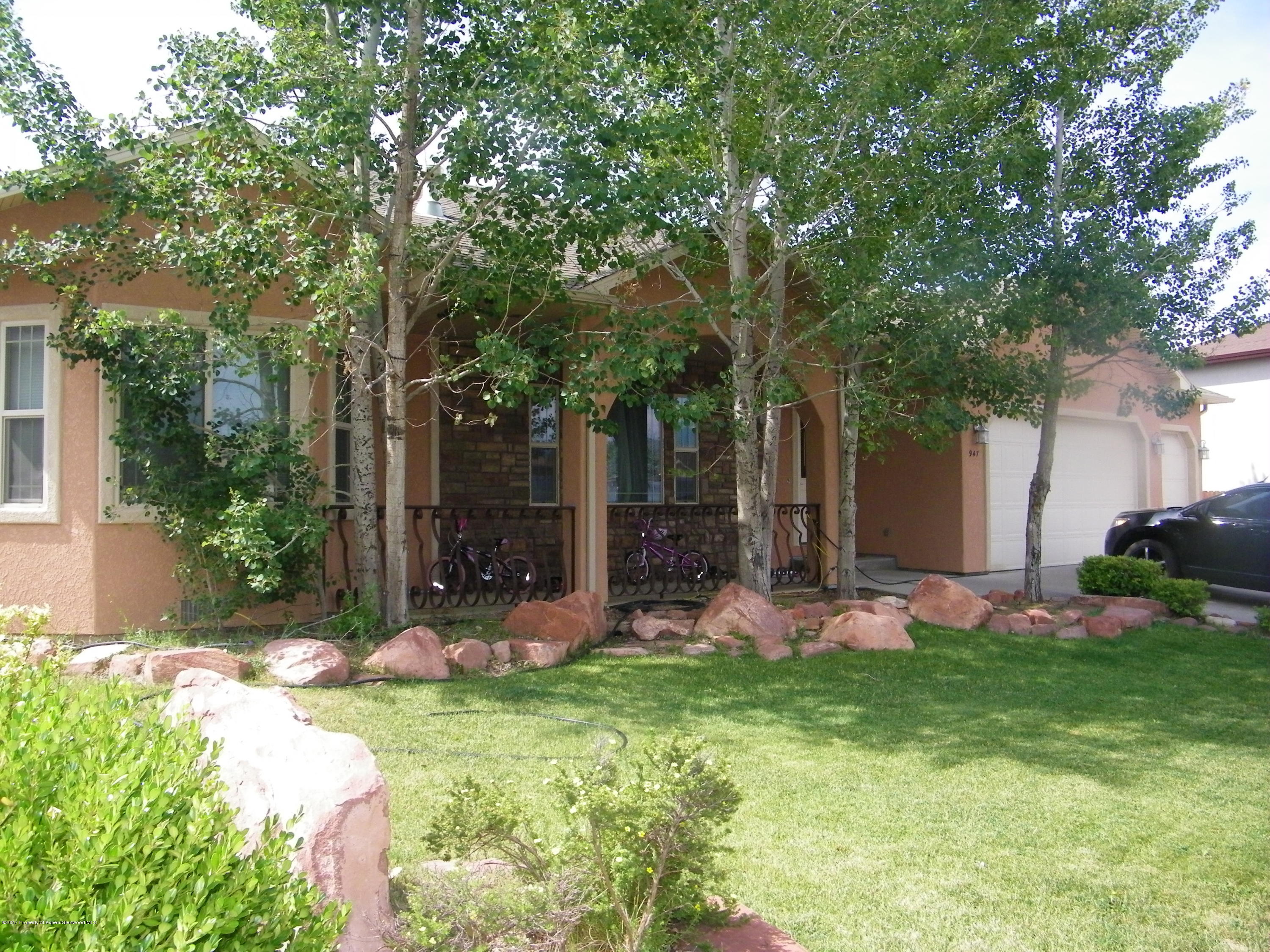 947 East 18th Street Rifle, CO 81650 - Photo 1 of 6 a front view of a house with garden and trees