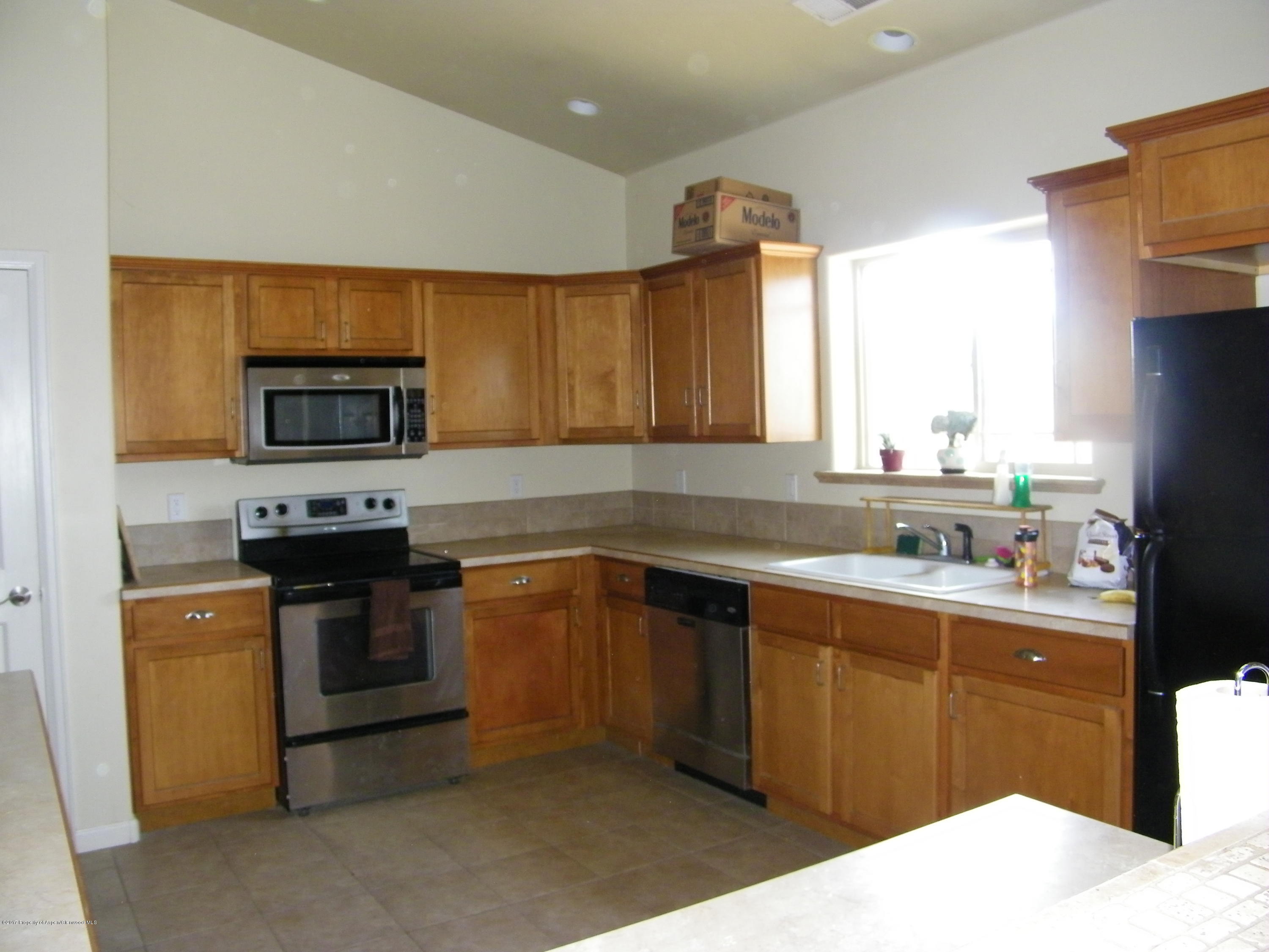947 East 18th Street Rifle, CO 81650 - Photo 3 of 6 a kitchen with a sink stove and microwave