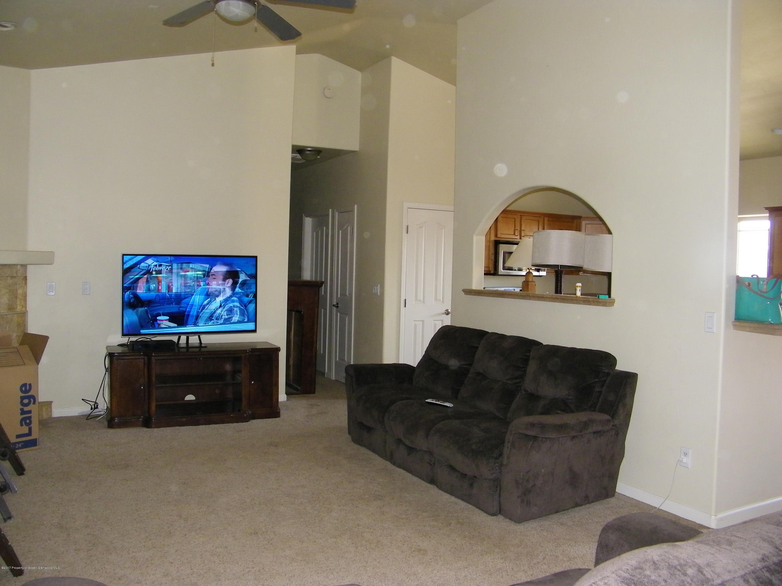 947 East 18th Street Rifle, CO 81650 - Photo 4 of 6 a living room with furniture a couch and a flat screen tv