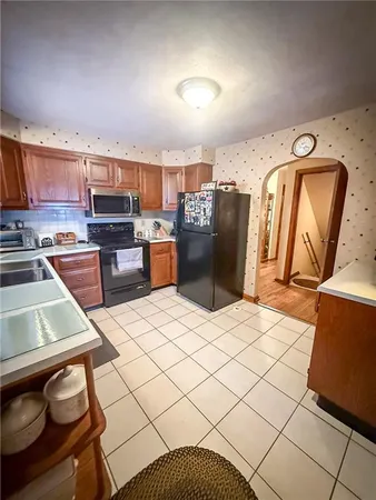a kitchen with stainless steel appliances granite countertop a refrigerator a stove top oven a sink and dishwasher