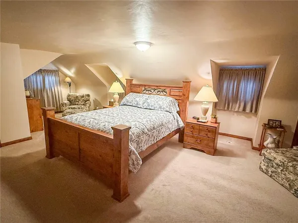 a spacious bedroom with a bed and a cabinets