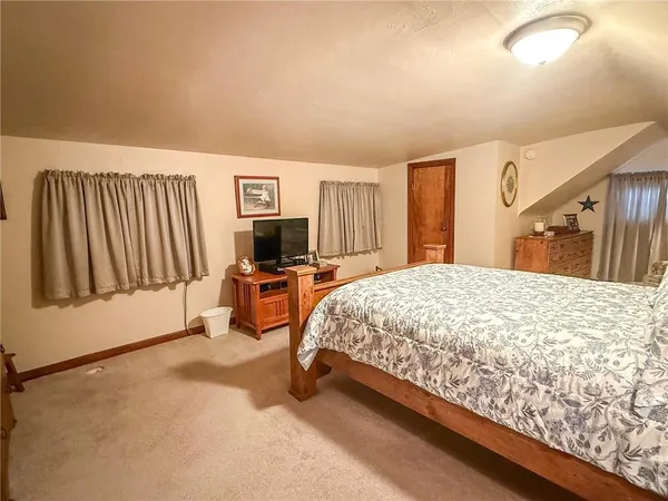 a bedroom with a bed and a large mirror