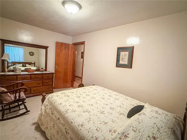 a bed room with a bed and a dresser