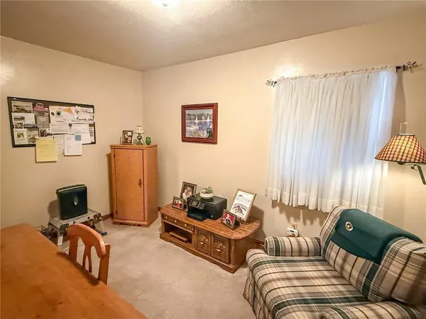 a view of a room with gym equipment and a window