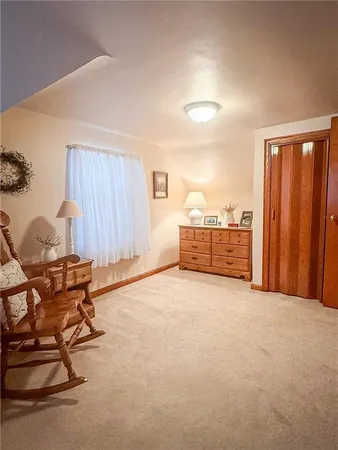 a view of a room with wooden floor and furniture