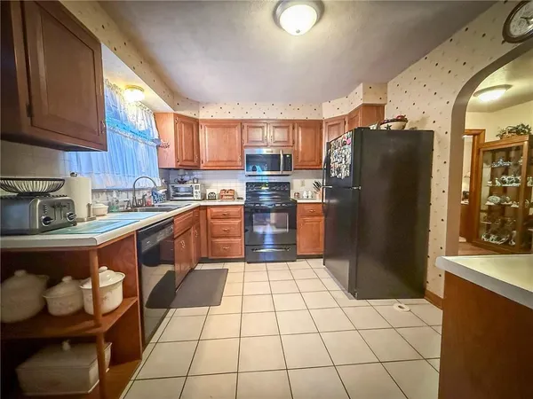 a kitchen with stainless steel appliances granite countertop a refrigerator and a stove top oven
