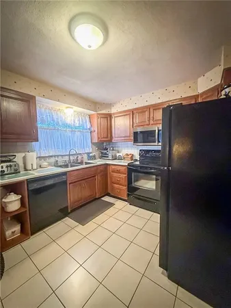 a kitchen with granite countertop stainless steel appliances and white cabinets