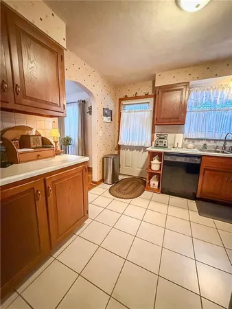a kitchen with a sink a stove and a refrigerator