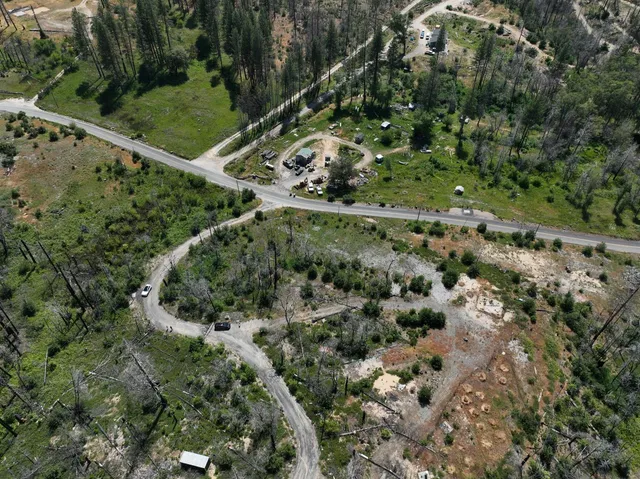 an aerial view of a residential houses with outdoor space