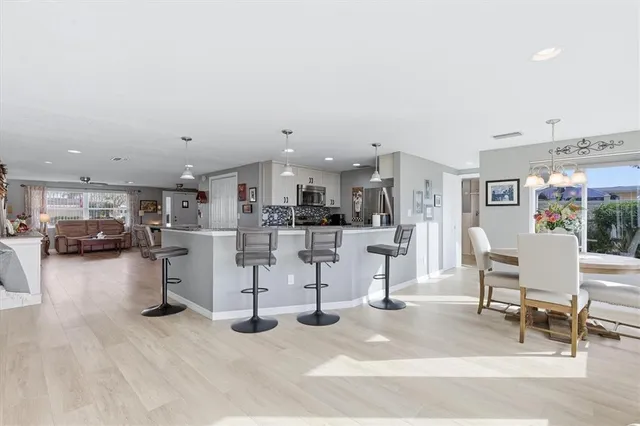 a kitchen with stainless steel appliances granite countertop a refrigerator and a stove top oven