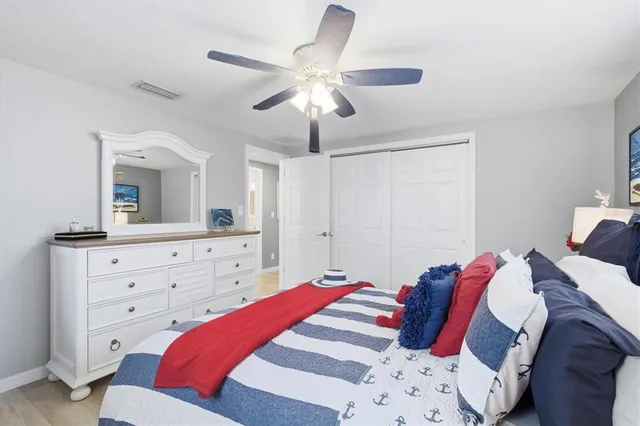 a living room with furniture a clock potted plant and a large window