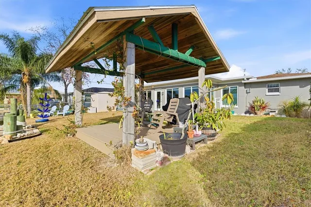 an aerial view of ocean and residential houses with outdoor space