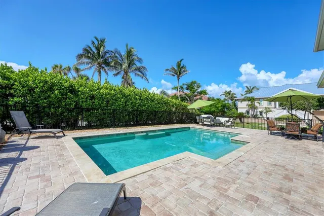 a view of a swimming pool with a table and chairs