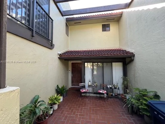 a backyard of a house with outdoor seating