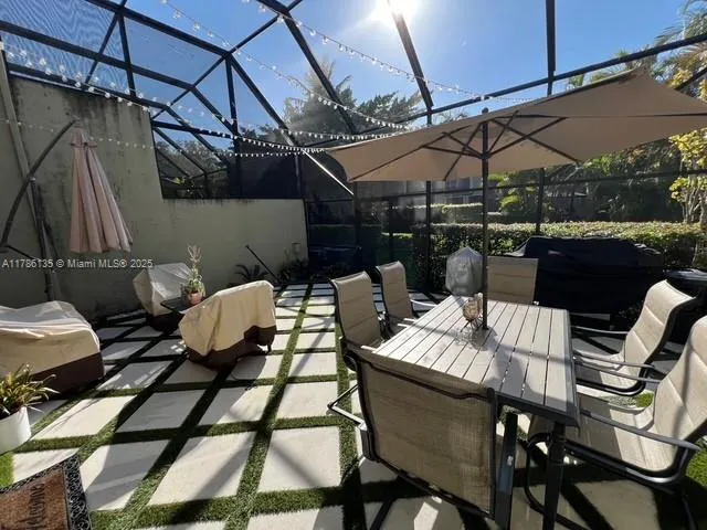 a living room with furniture and a floor to ceiling window
