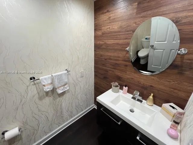 a bedroom with a bed and a flat tv screen on a dresser