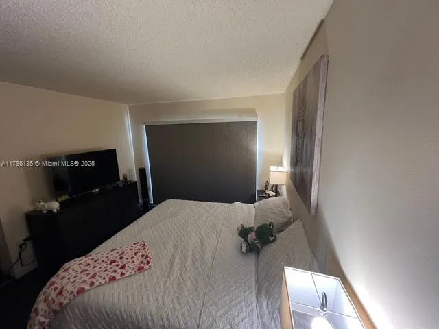a room with a bed and a flat screen tv