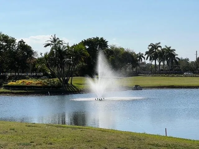 a view of swimming pool with a yard and large trees