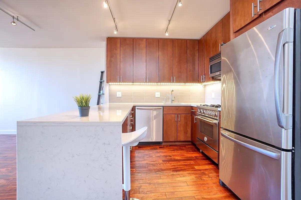 255 East 49th Street, Unit 31C Manhattan, NY 10017 - Photo 4 of 11 a kitchen with a refrigerator sink and stove