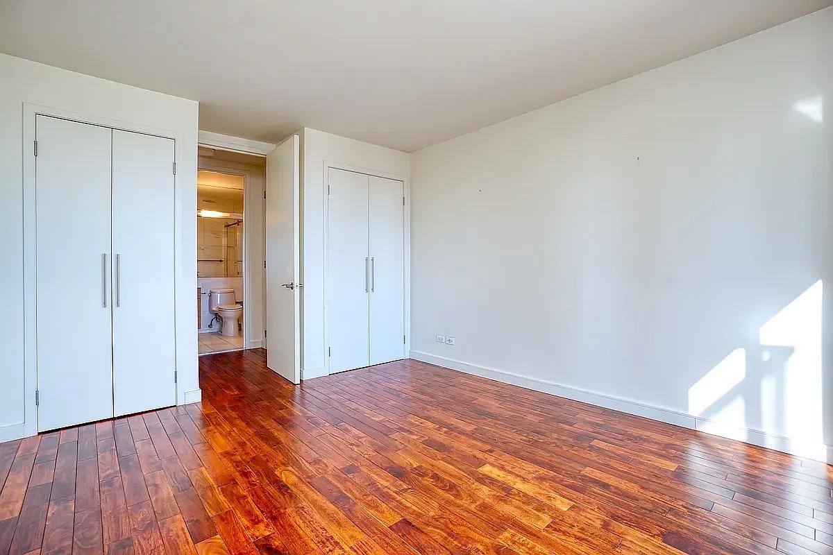 255 East 49th Street, Unit 31C Manhattan, NY 10017 - Photo 9 of 11 a view of an empty room and wooden floor
