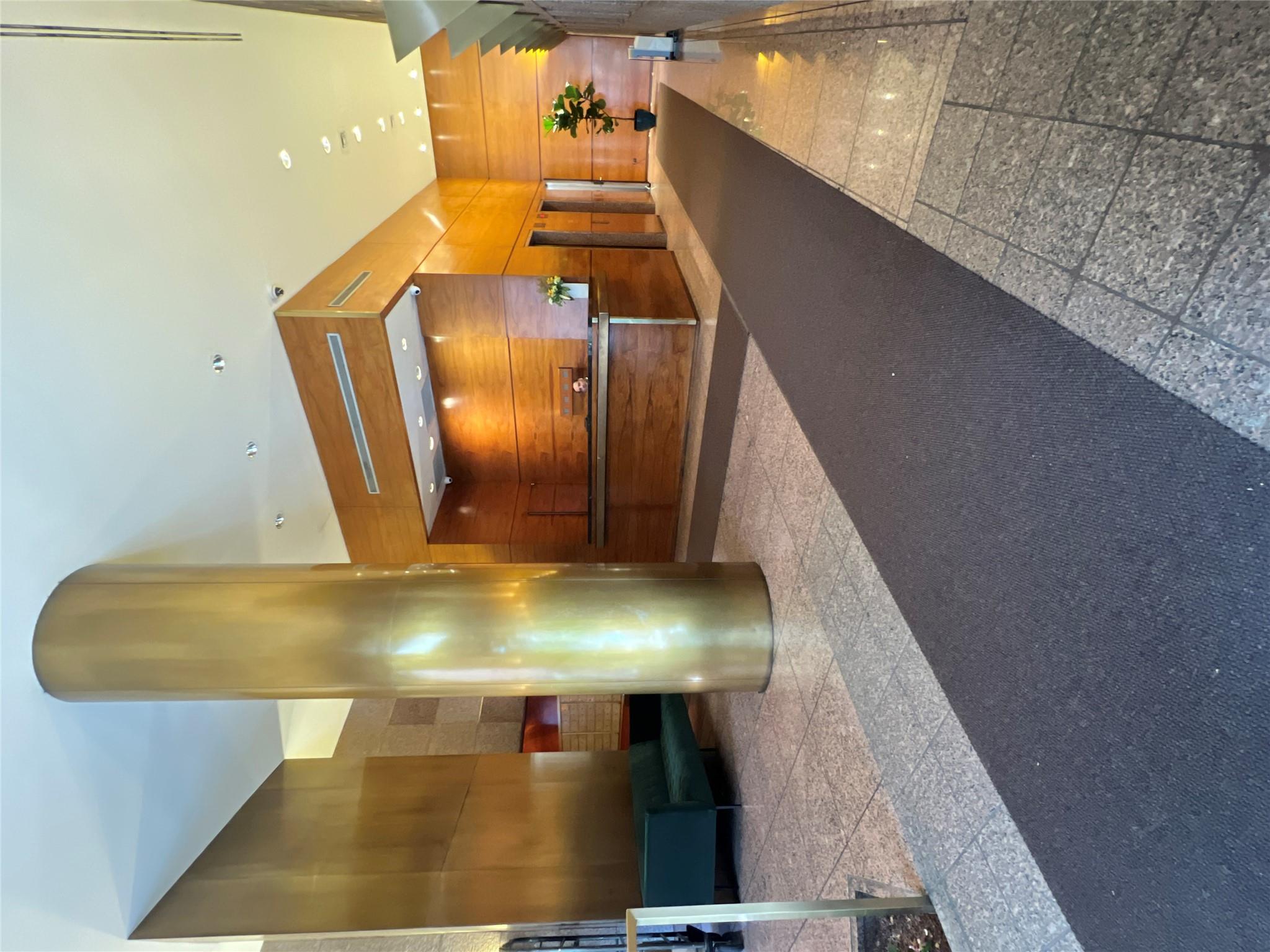 255 East 49th Street, Unit 31C Manhattan, NY 10017 - Photo 10 of 11 a view of lobby with a couch and a rug