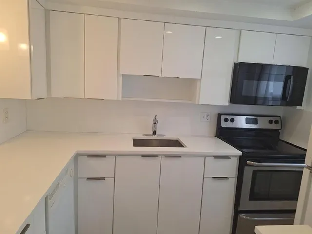 a kitchen with a sink and cabinets