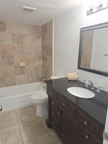 a bathroom with a sink a toilet and bathtub