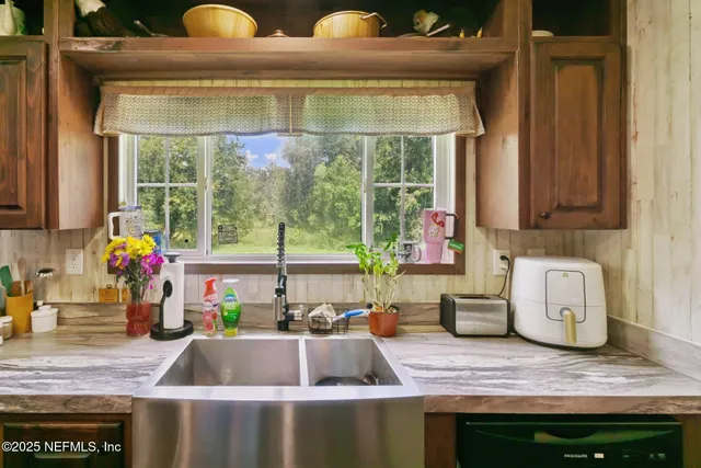 a kitchen with a stove a sink and a wooden cabinets