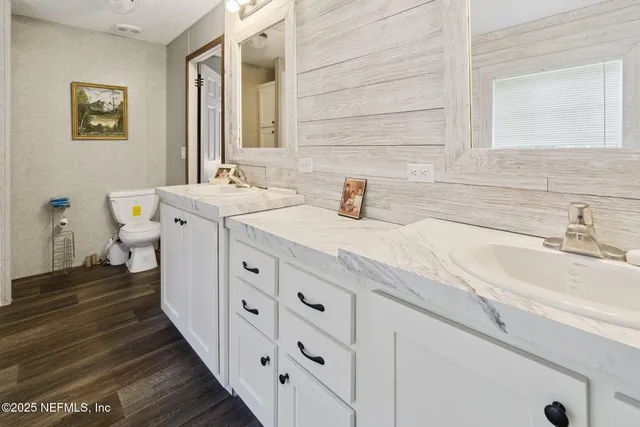 a spacious bathroom with double vanity sink and a mirror