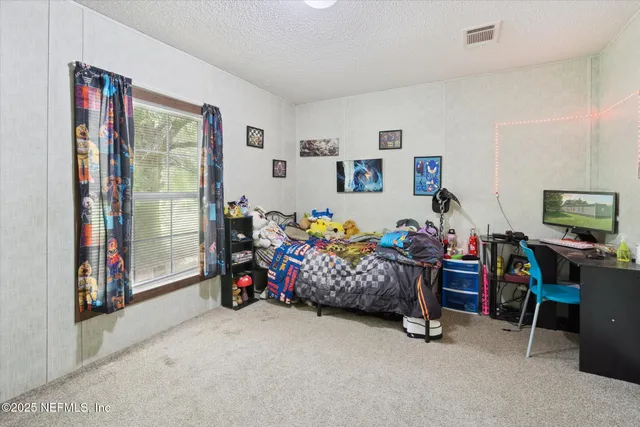 a bedroom with furniture and a fan