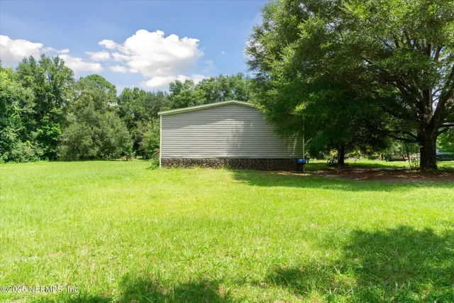 a view of backyard with green space