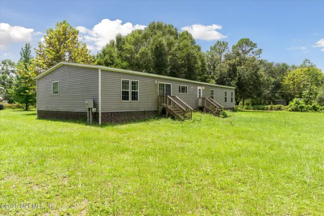 a backyard of a house with wooden fence and trees
