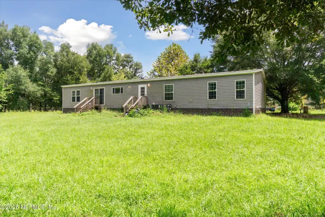 a backyard of a house with yard and garage