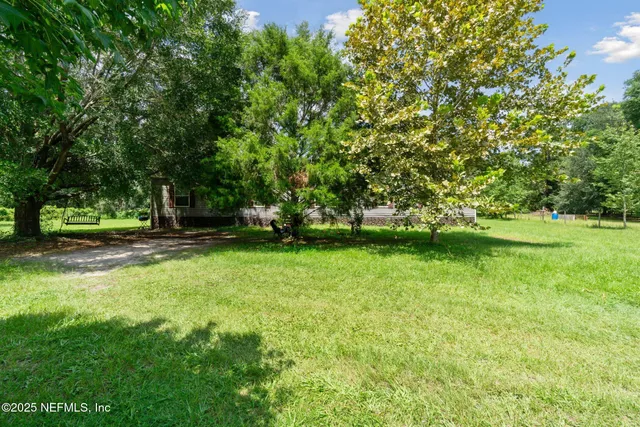 a view of outdoor space with deck and yard